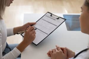 high angle patient filling consent document